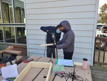 Club members working on wood working project