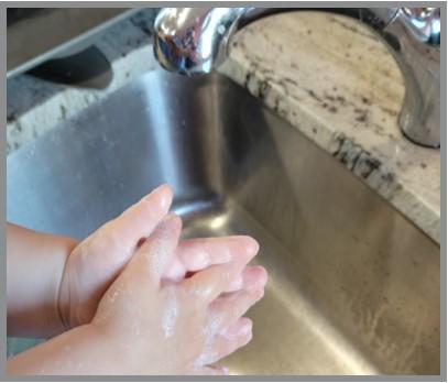 Youth washing their hands, lathering for 20 seconds before rinsing hands with water and drying with a clean paper towel.