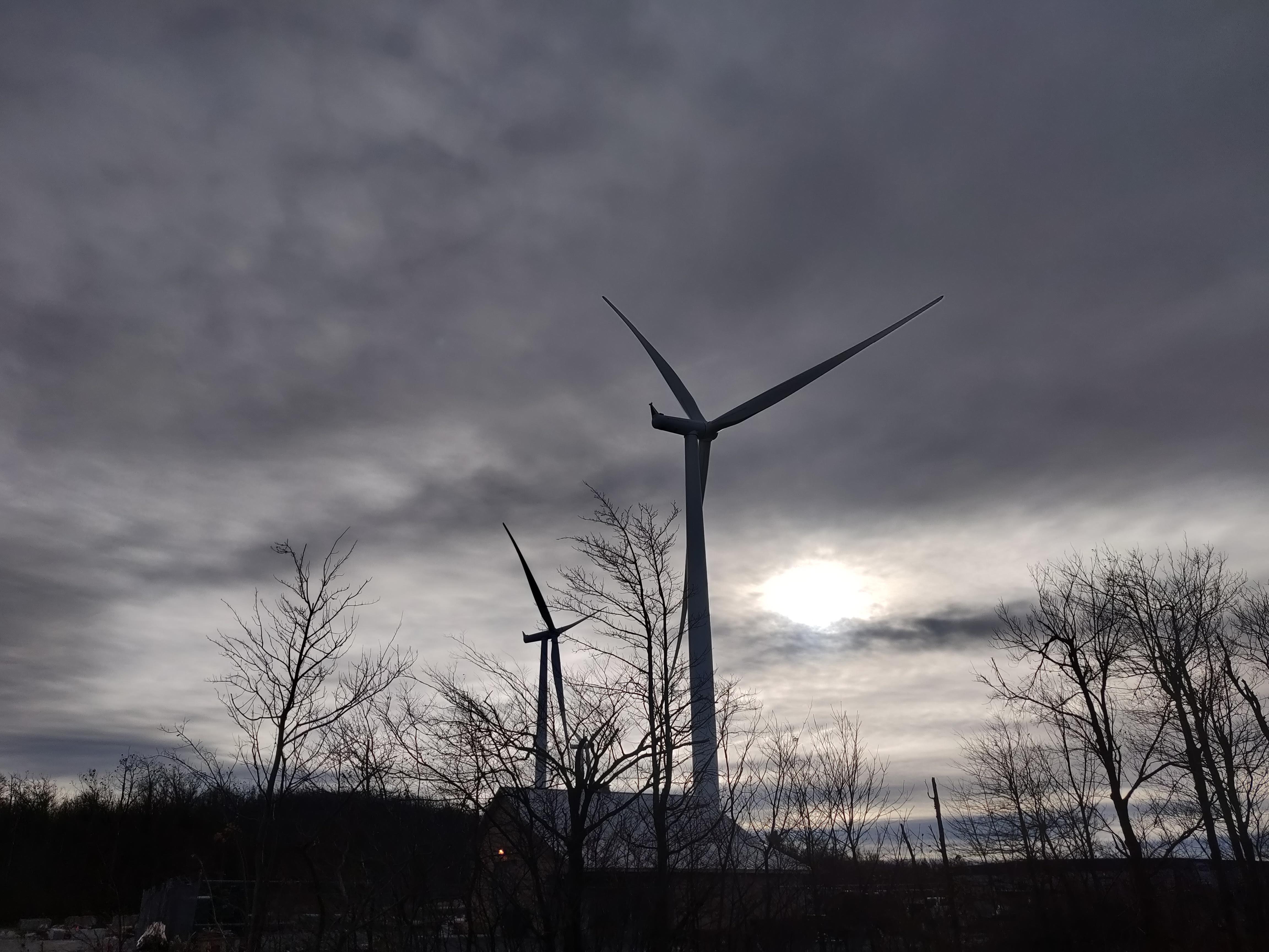 Wind turbine in overcast sky