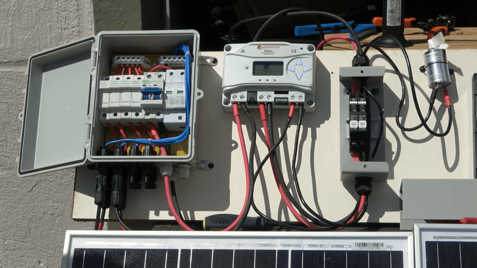 Wiring a simple solar photovoltaic (PV) system with a combiner box, charge controller, and breaker box