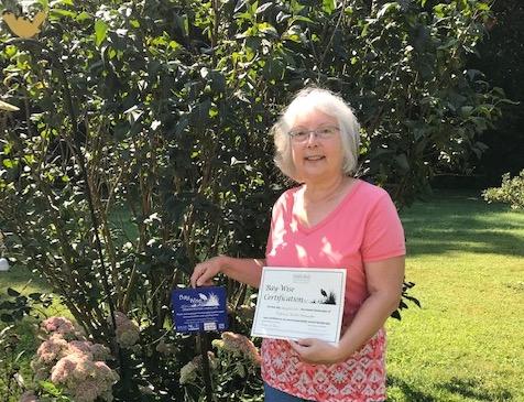 Woman showing off Bay-Wise certification