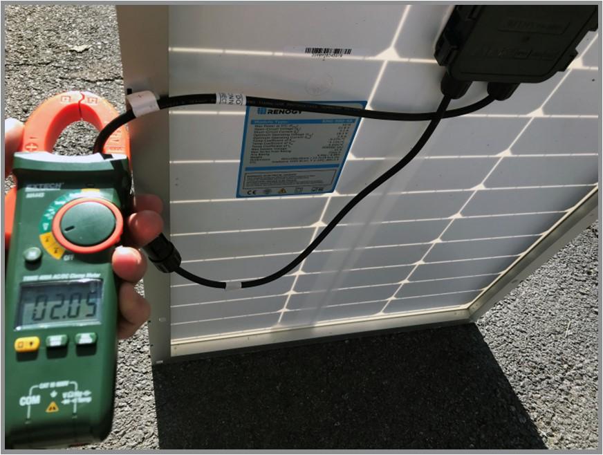 digital clamp-on multimeter and solar panel