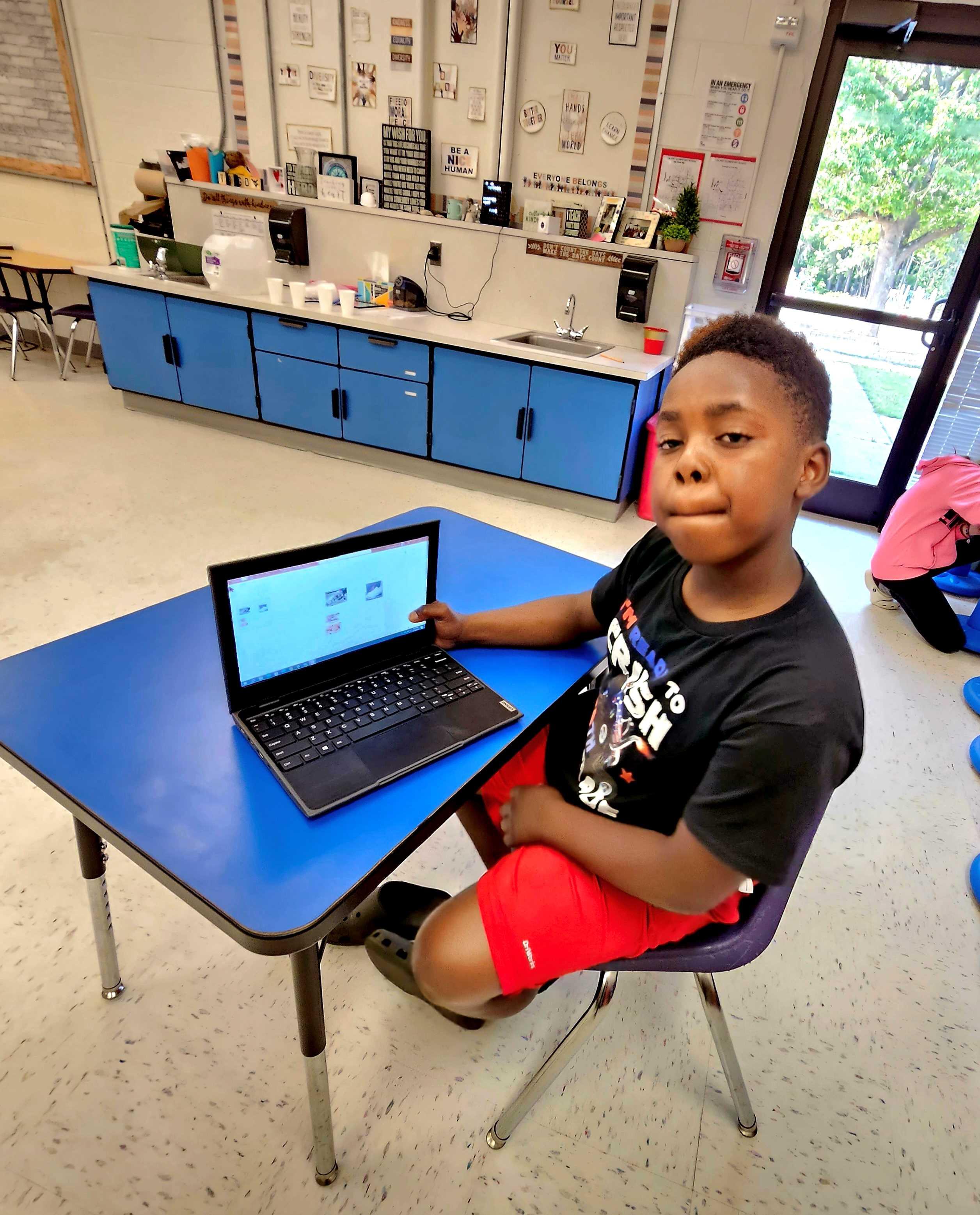 Boy using Powerpoint to create self portrait