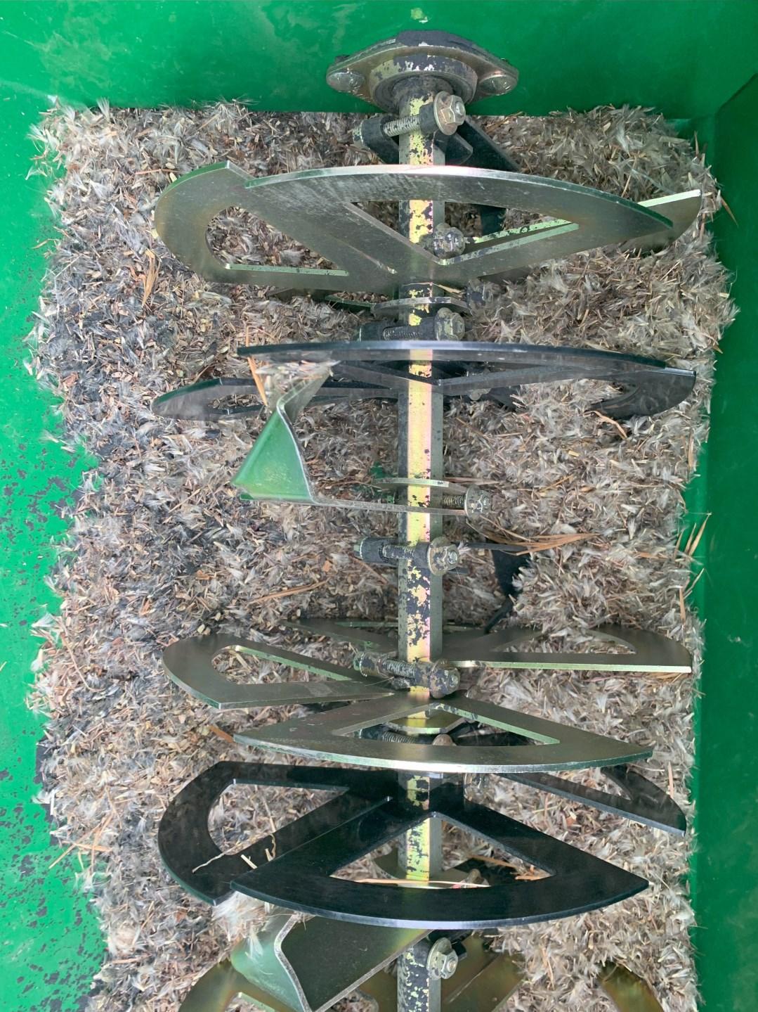Native seed drill's agitator wheels that rotate to aid seed dropping.