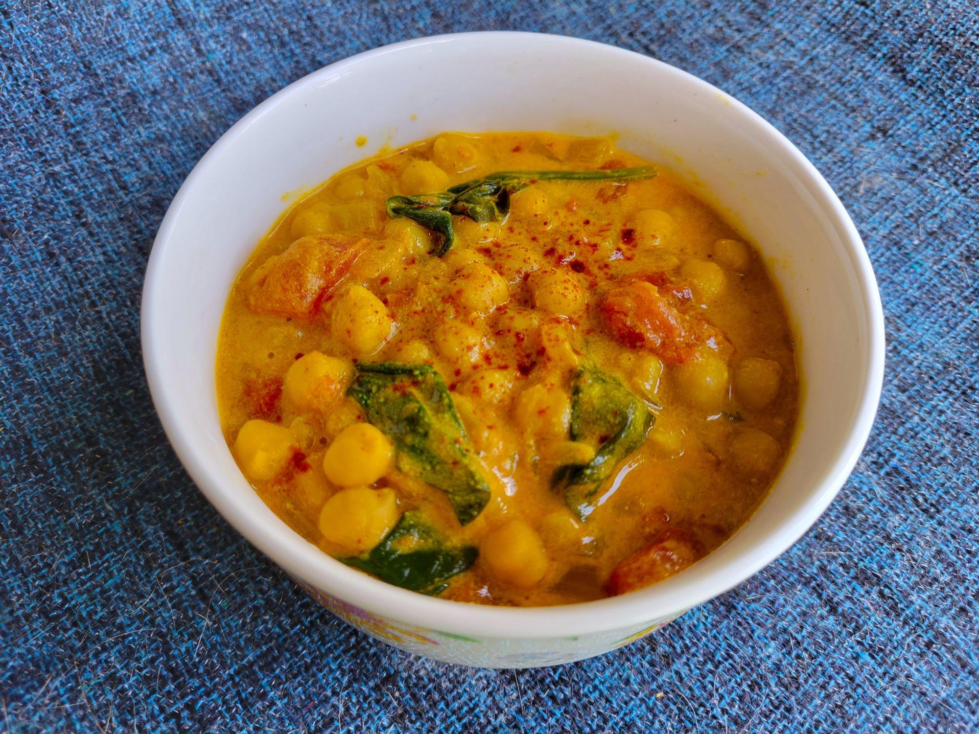 A white bowl with chickpea curry.