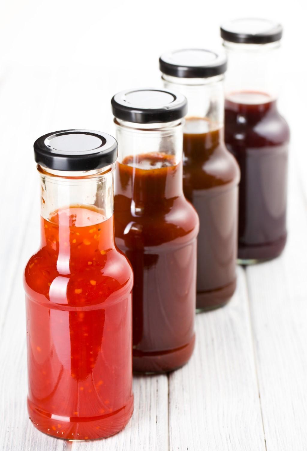 Four bottles containing BBQ sauce