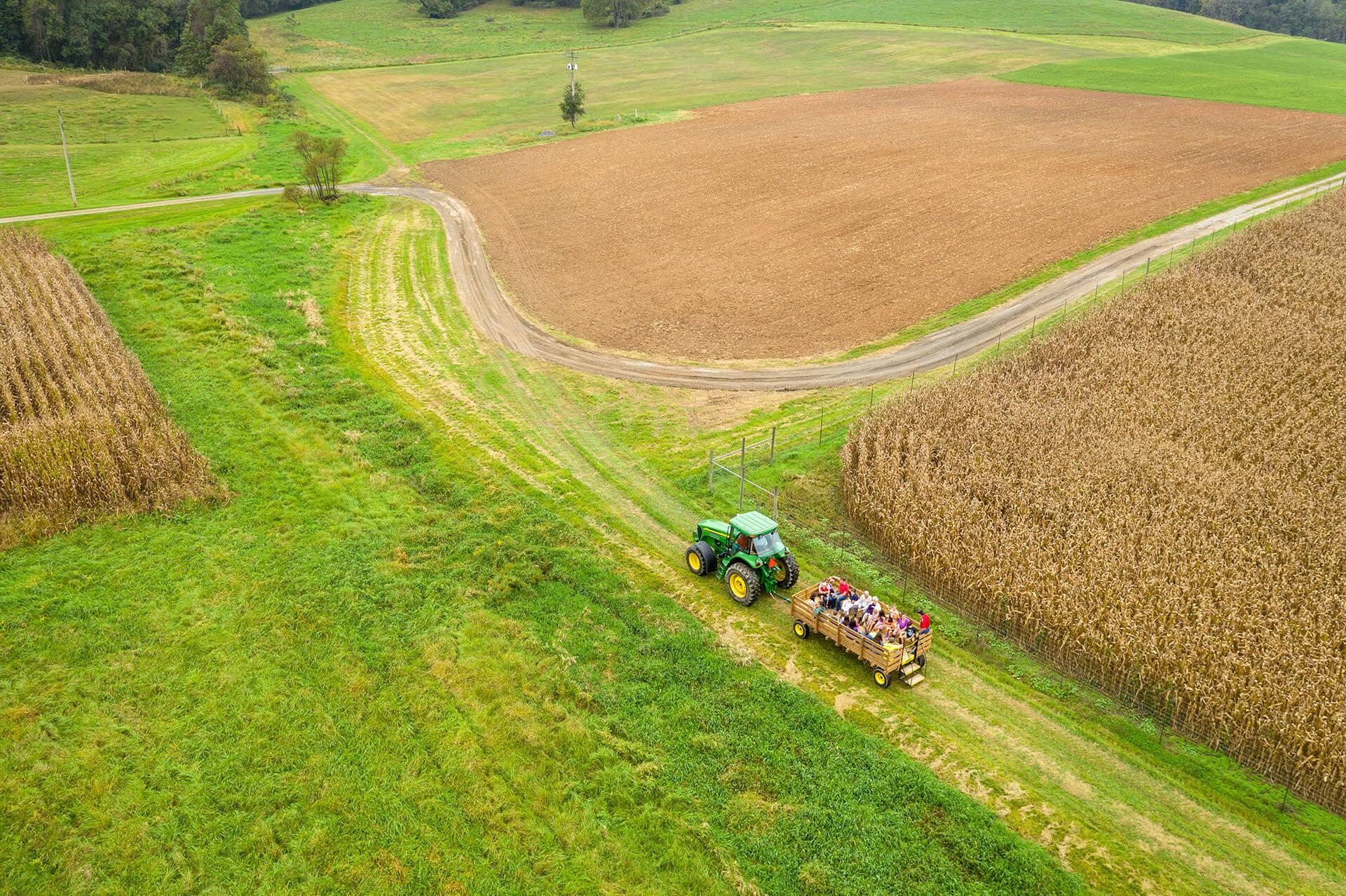 Aerial image of CMREC fields with tractor pulling a group of people