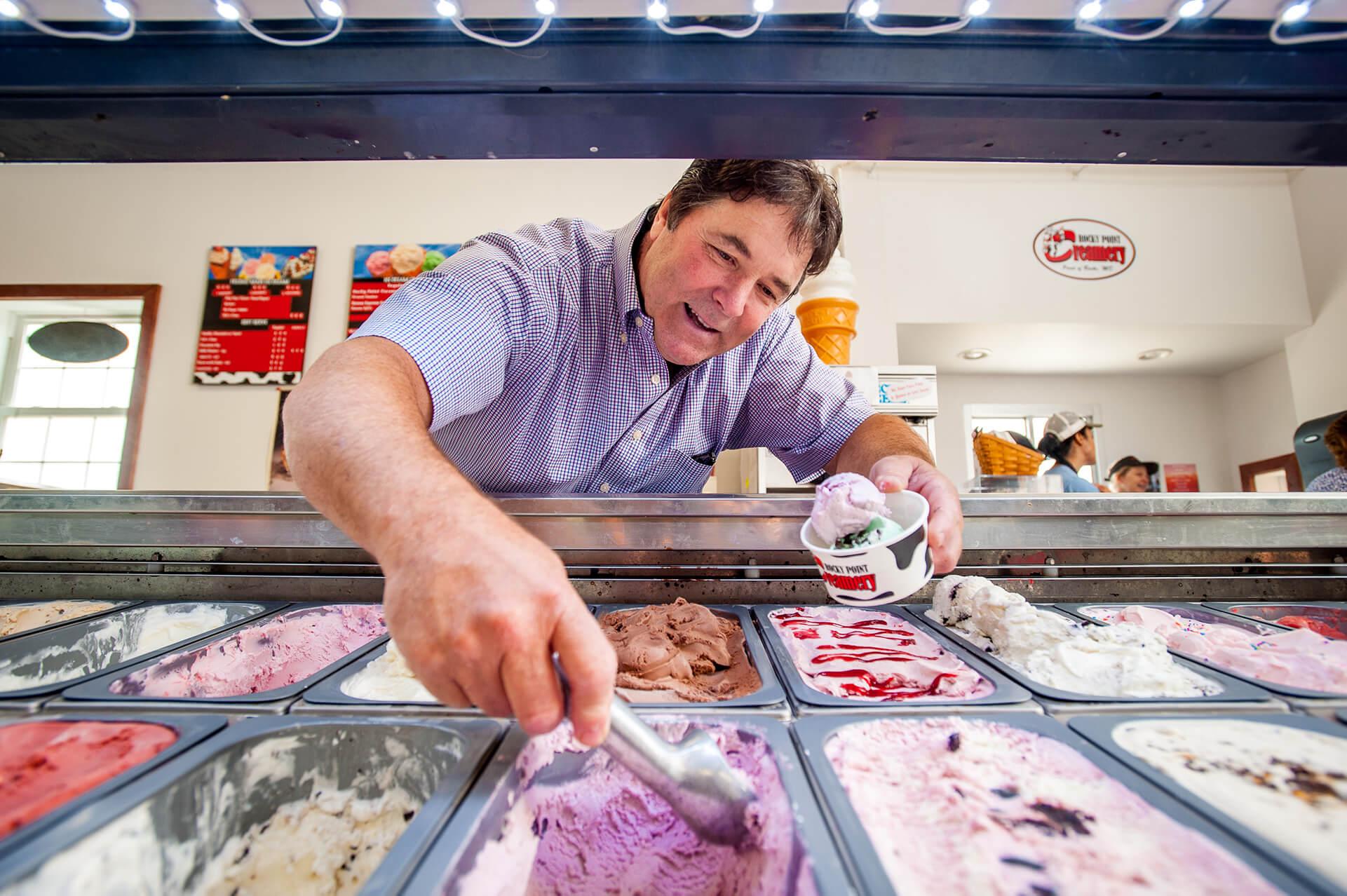 Person scooping ice cream at Rocky Point Creamery