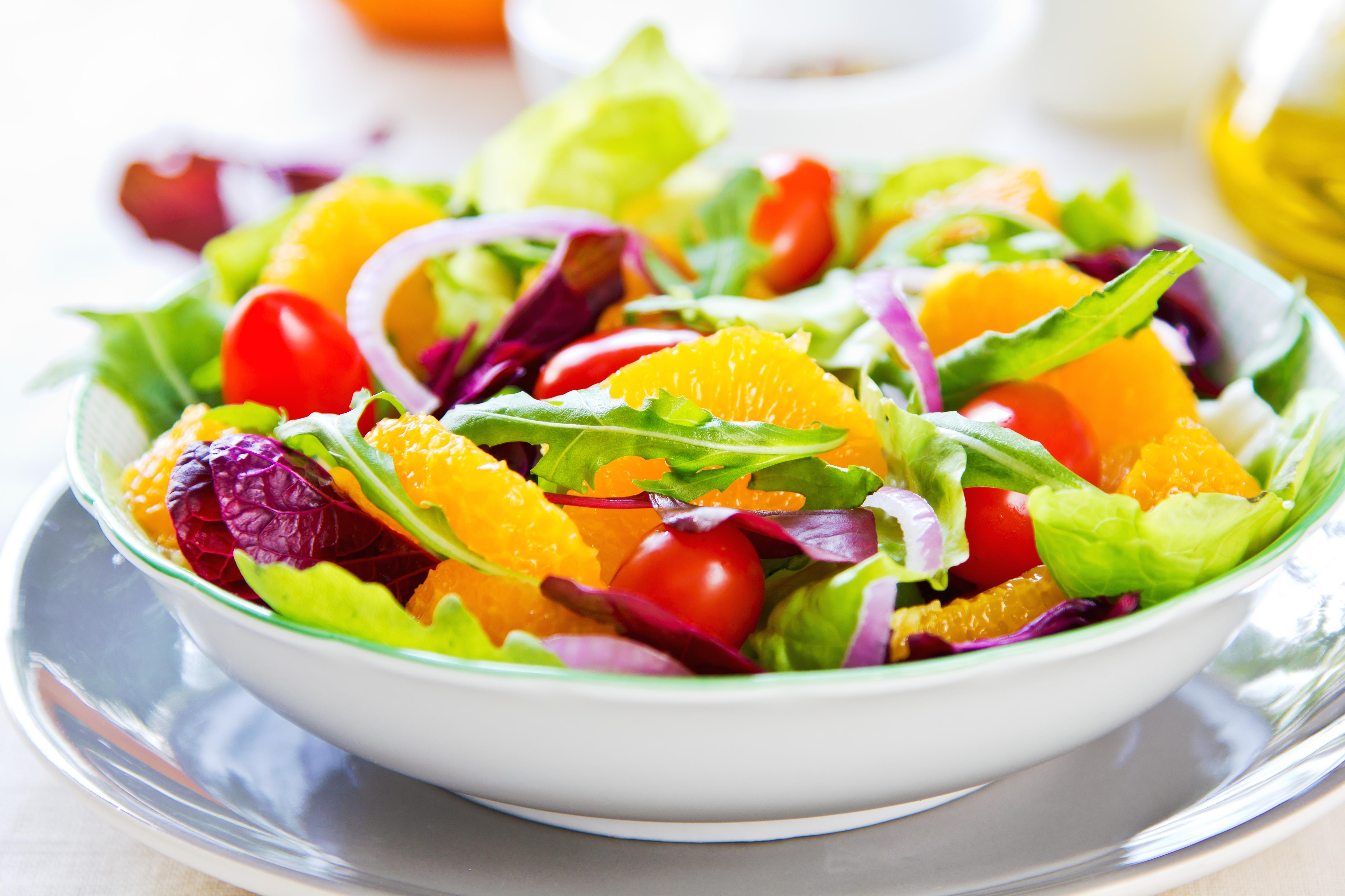 Colorful salad with tomatoes and canned mandarin oranges.