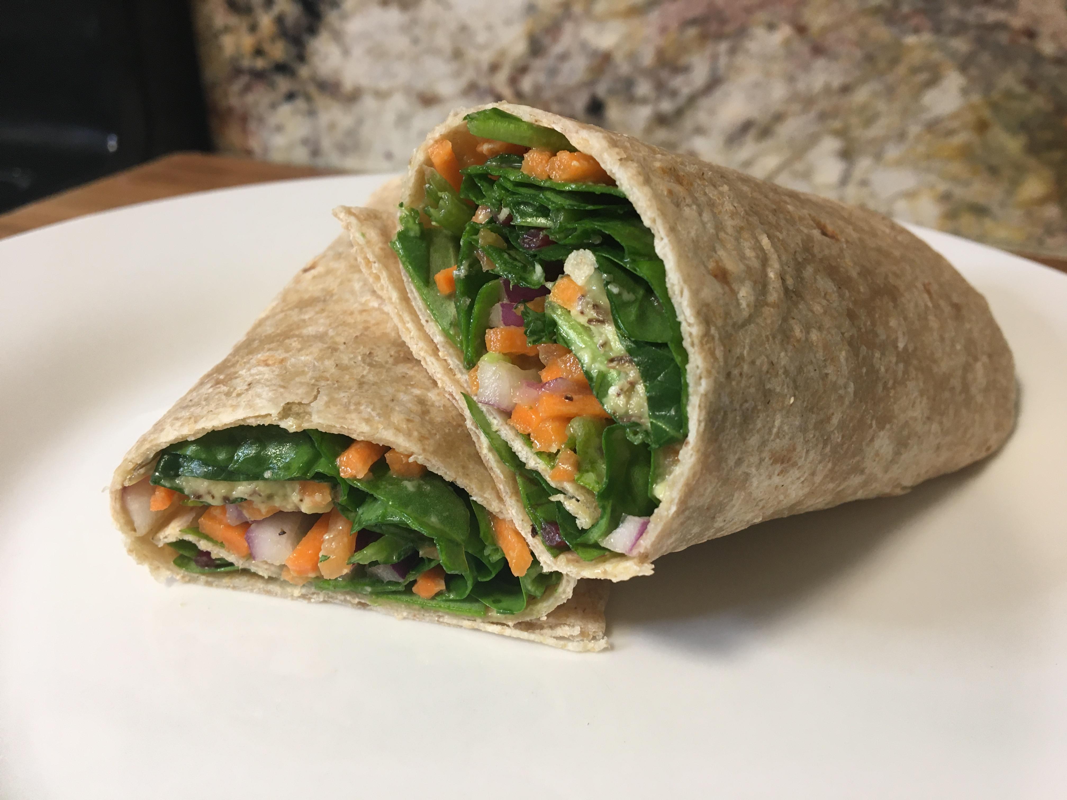 Whole wheat tortilla filled with swiss chard, avocado, tomato and carrots.