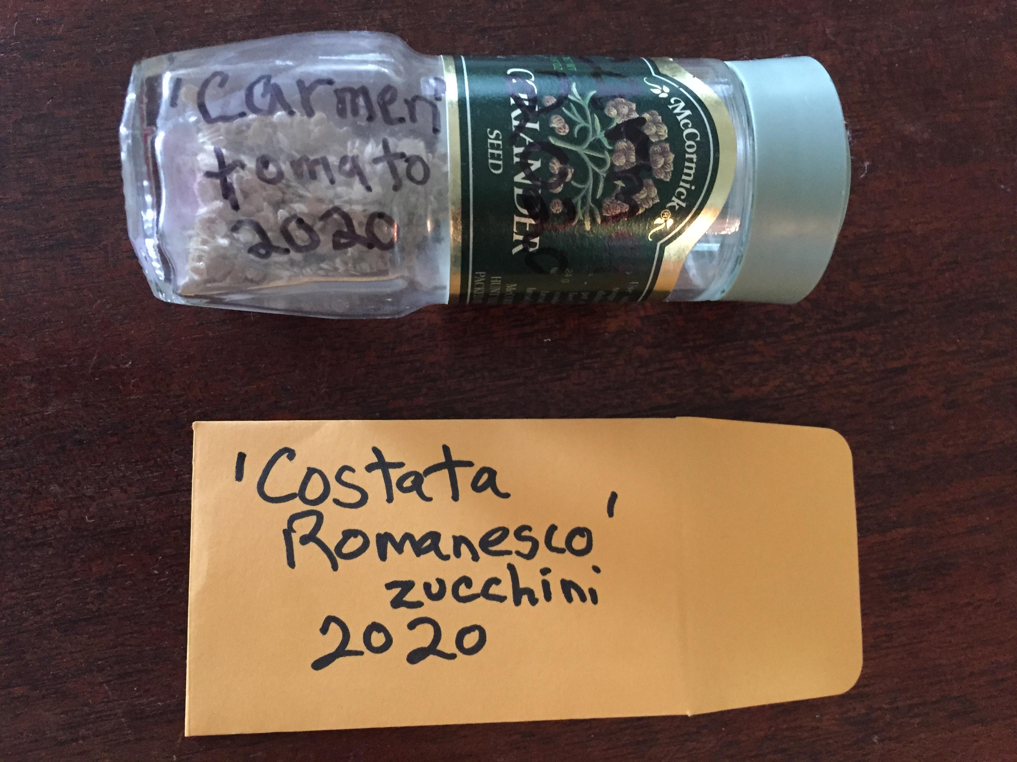 vegetable seeds stored in a small glass jar and small brown envelope