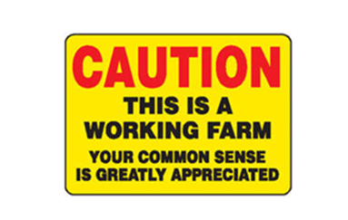 Caution sign this is a working farm