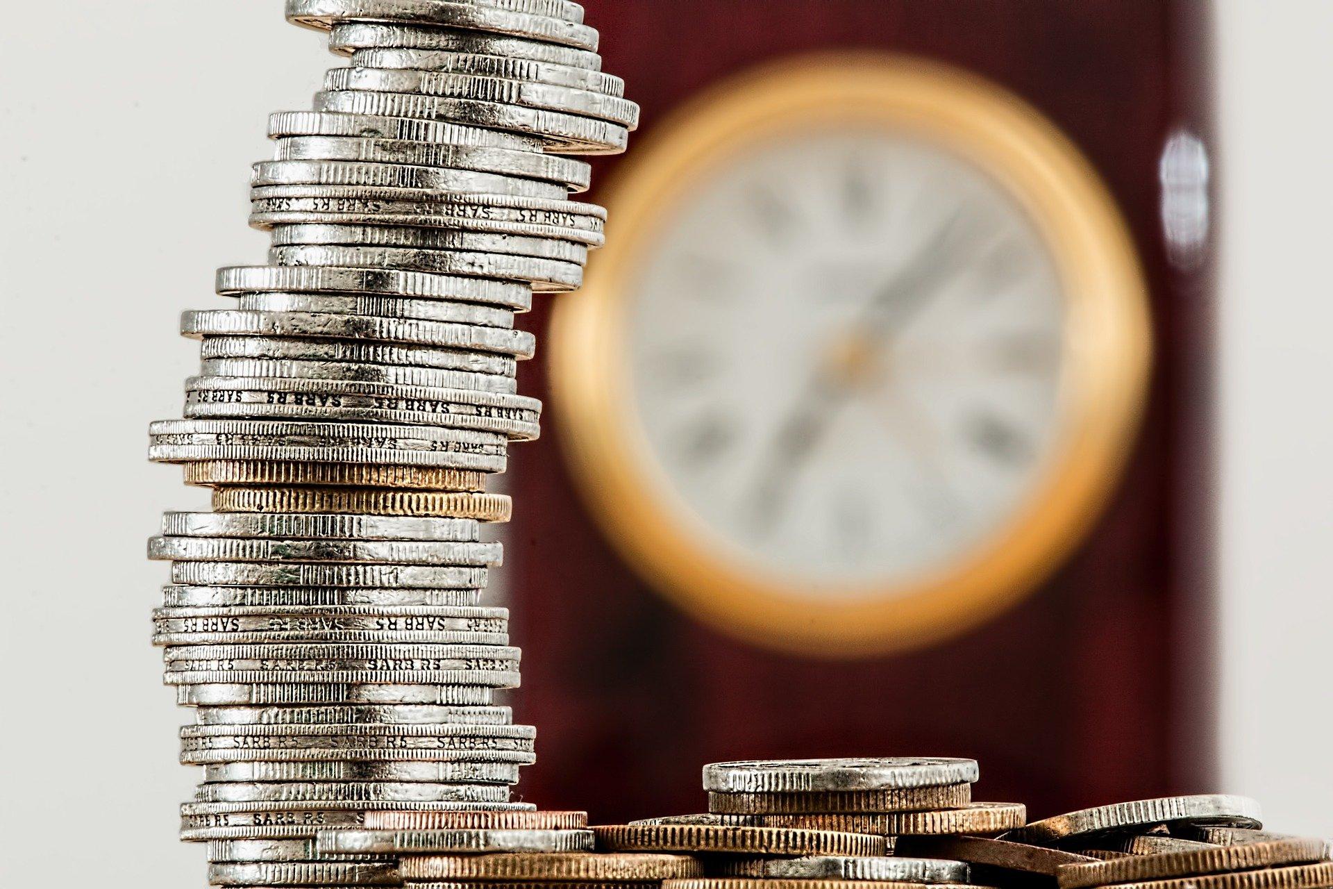 Coins with clock in the background