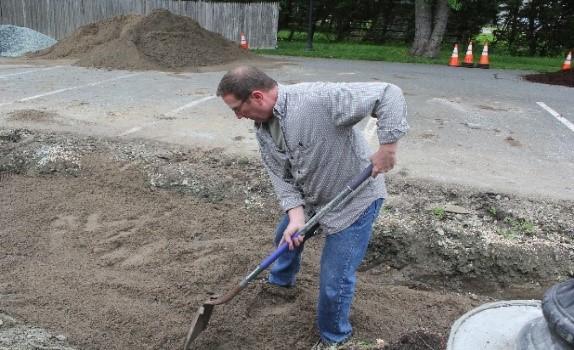 Mark shoveling planting media into the capstone project. Image: Van Funk, Cecil County.