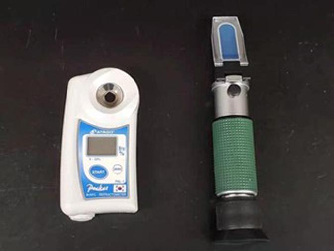 Figure 6. A hand-held manual refractometer (right) and digital refractometer (left) for measuring soluble solids contents of extracted peach juice sample. Source: Yixin Cai, University of Maryland
