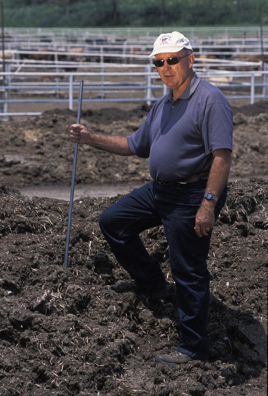 Man standing in manure in livestock pen