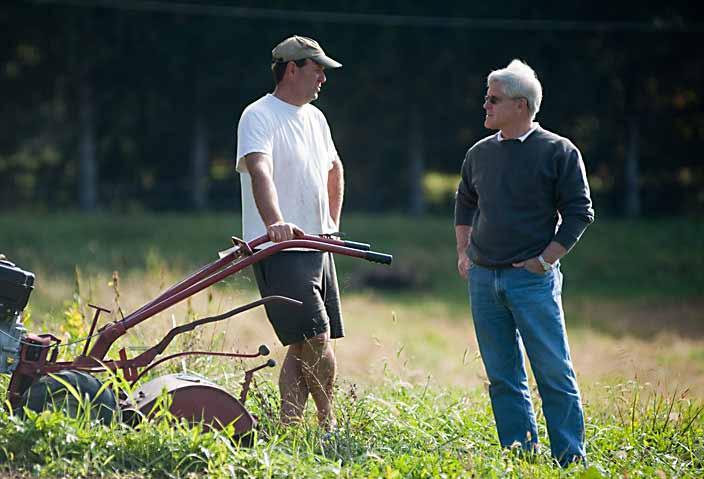 Farmer consulting with Extension agent