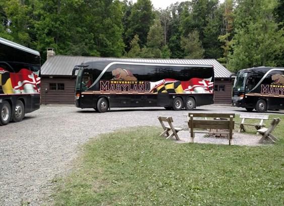 ?Several buses are parked at a 4-H camp