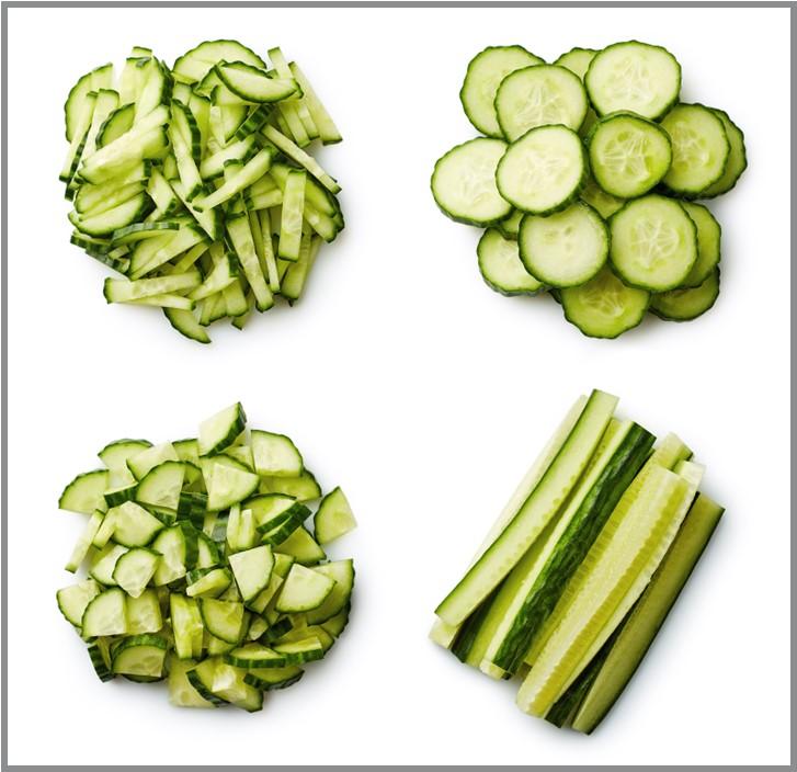 Raw cucumbers chopped in circles, sticks, quarters, halves, and slivers.