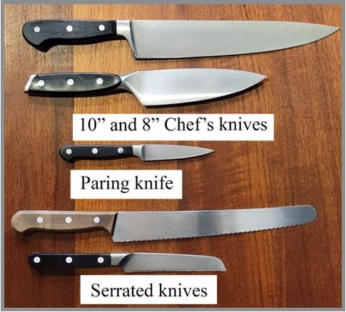 A group of knives, chef's knife of varying lengths, a paring knife, and serrated knives of varying lengths.