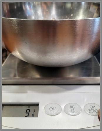 A scale with an empty bowl on it, and the bowl weight has not been tared, or reading zero. When weighing ingredients you do not want to include the weight of the bowl so taring or zeroing will let you remove the weight of the bowl. 