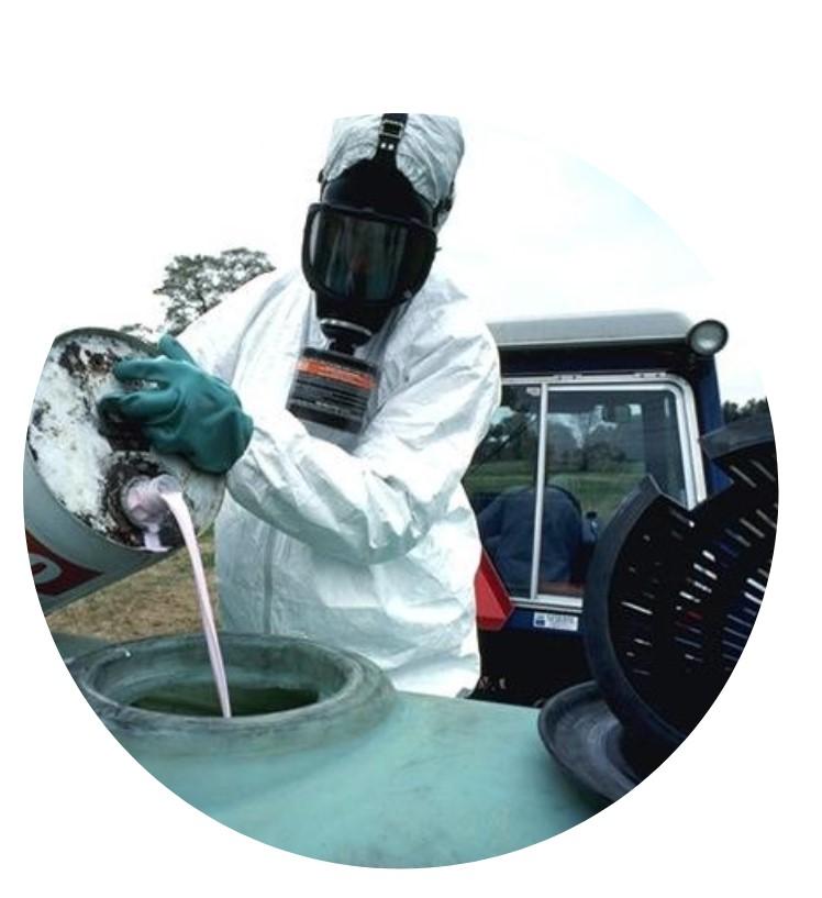 Pesticide applicator pouring liquid into sprayer