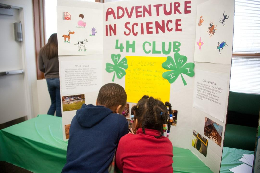 youth looking at a 4-H table display