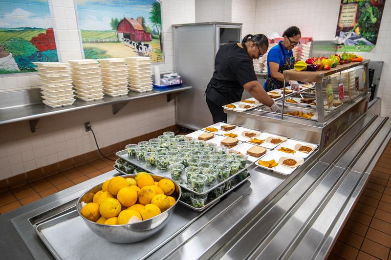 Cafeteria workers at Princess Anne Elementary prepare to serve Tropical Somerset Salad