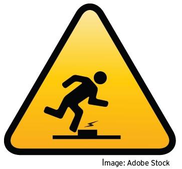 A yellow warning sign with the image of a person falling is typically used in areas where there is a risk of falling. 