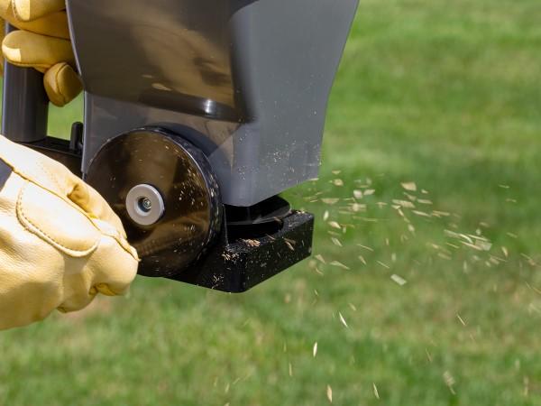 Handheld rotary spreader consisting of a small basin dropping material onto a spinning disc below, which is rotated with a hand crank.