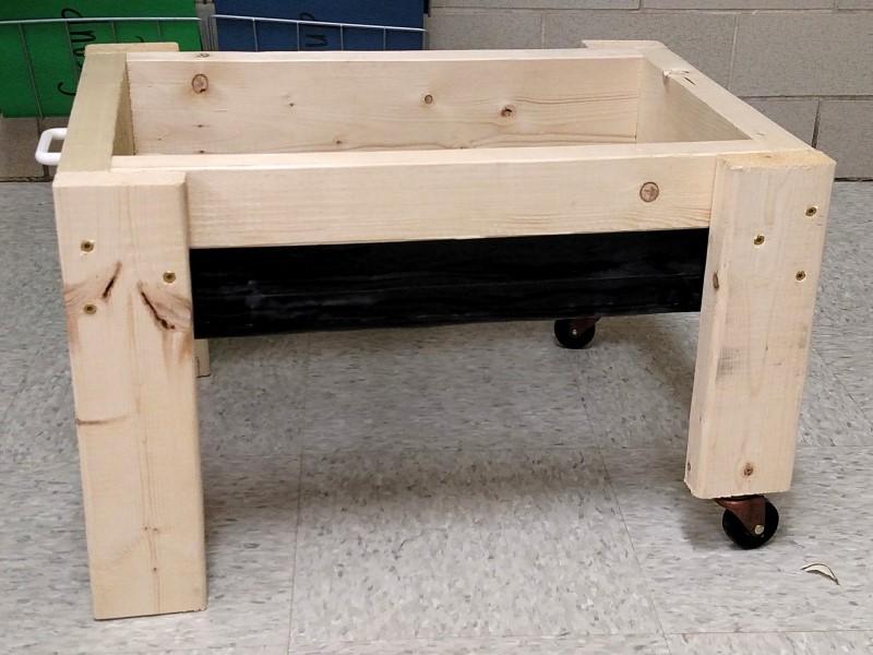 Small Salad Table with no internal divisions and casters added to shortened legs on one end.