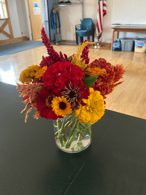 Cut fall flowers in a vase on a table in a conference room
