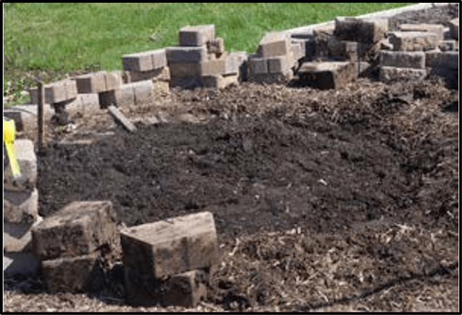 Preparation site showing dirt and concrete pavers
