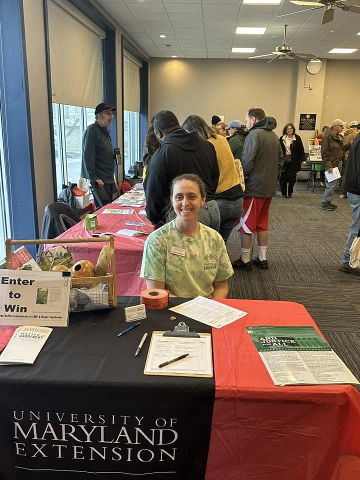 MG Coordinator Sarah Llewellyn at Seed Exchange red/black table cloth sign in sheet