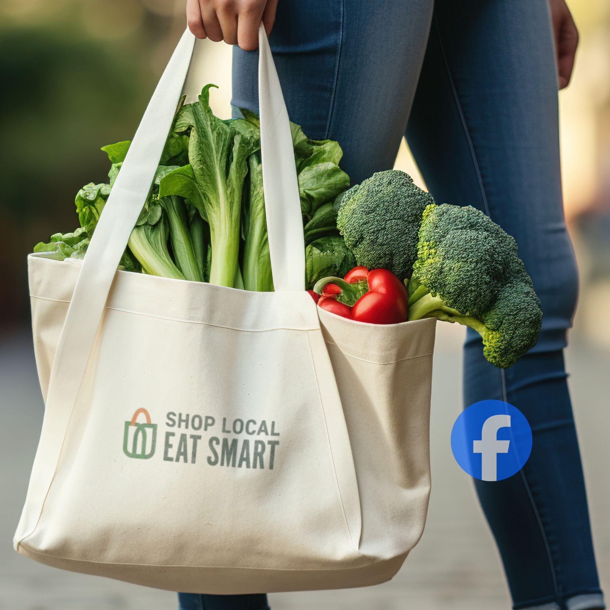 Woman carrying a Shop Local Eat Smart logo'd canvas bag with produce sticking out the top