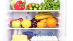 refrigerator shelves showing fruit, cheese, eggs and vegetables